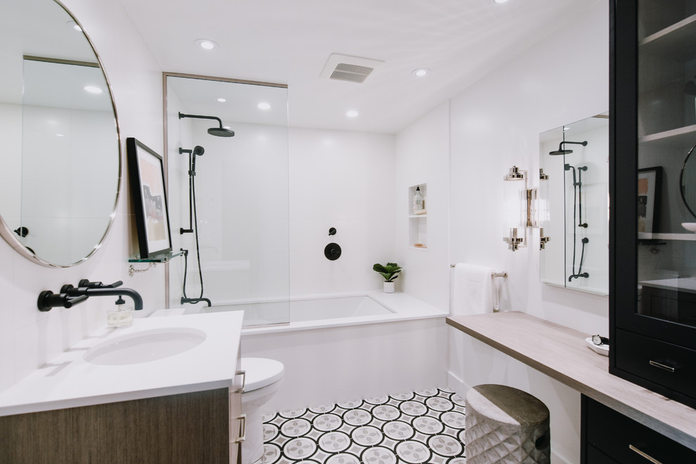 Bathroom - mid-sized contemporary 3/4 white tile and ceramic tile porcelain tile and gray floor bathroom idea in Montreal with flat-panel cabinets, medium tone wood cabinets, an undermount tub, a two-piece toilet, white walls, an undermount sink, quartz countertops and white countertops