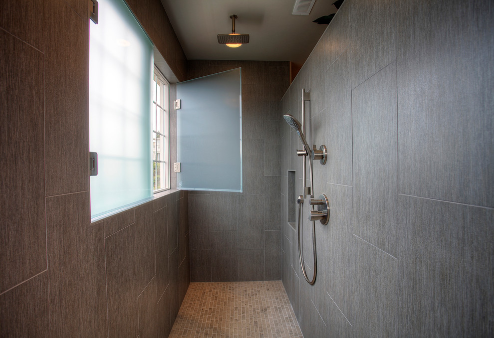 This is an example of a large contemporary ensuite bathroom in Seattle with flat-panel cabinets, medium wood cabinets, a built-in shower, grey tiles, ceramic tiles, ceramic flooring, a submerged sink and engineered stone worktops.