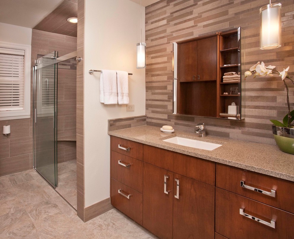 Medium sized contemporary ensuite bathroom in Seattle with a submerged sink, flat-panel cabinets, medium wood cabinets, engineered stone worktops, a built-in shower, a one-piece toilet, beige tiles, porcelain tiles, beige walls and porcelain flooring.