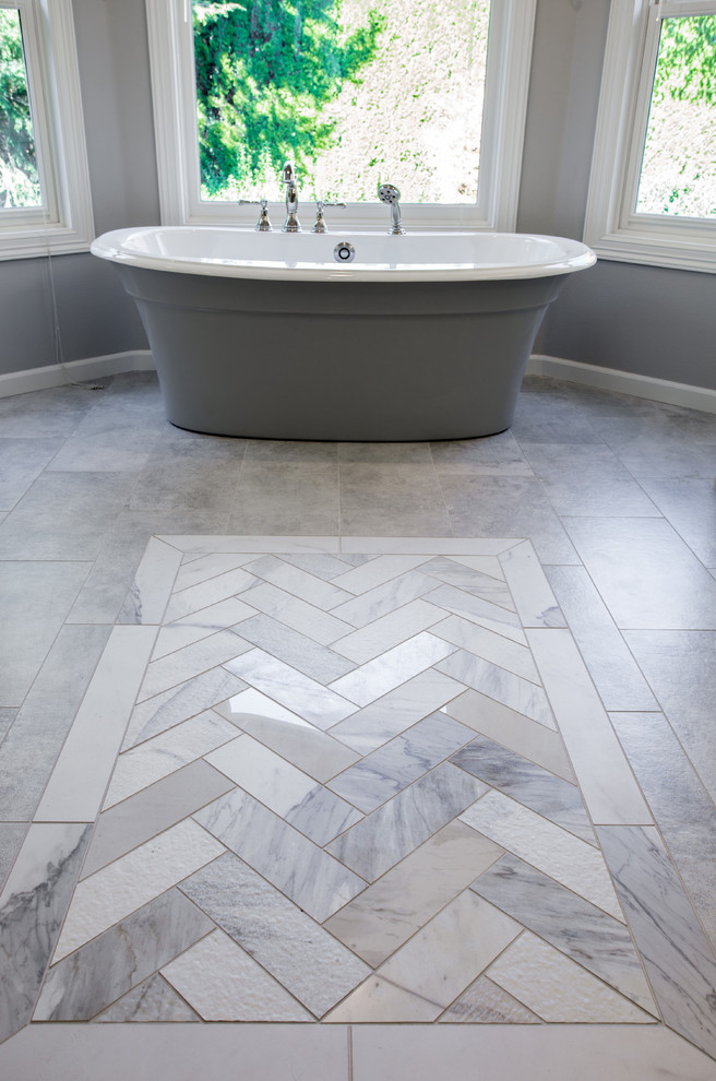 Example of a huge transitional master gray tile and porcelain tile marble floor and gray floor bathroom design in Portland with furniture-like cabinets, white cabinets, a two-piece toilet, gray walls, an undermount sink, marble countertops, a hinged shower door and gray countertops