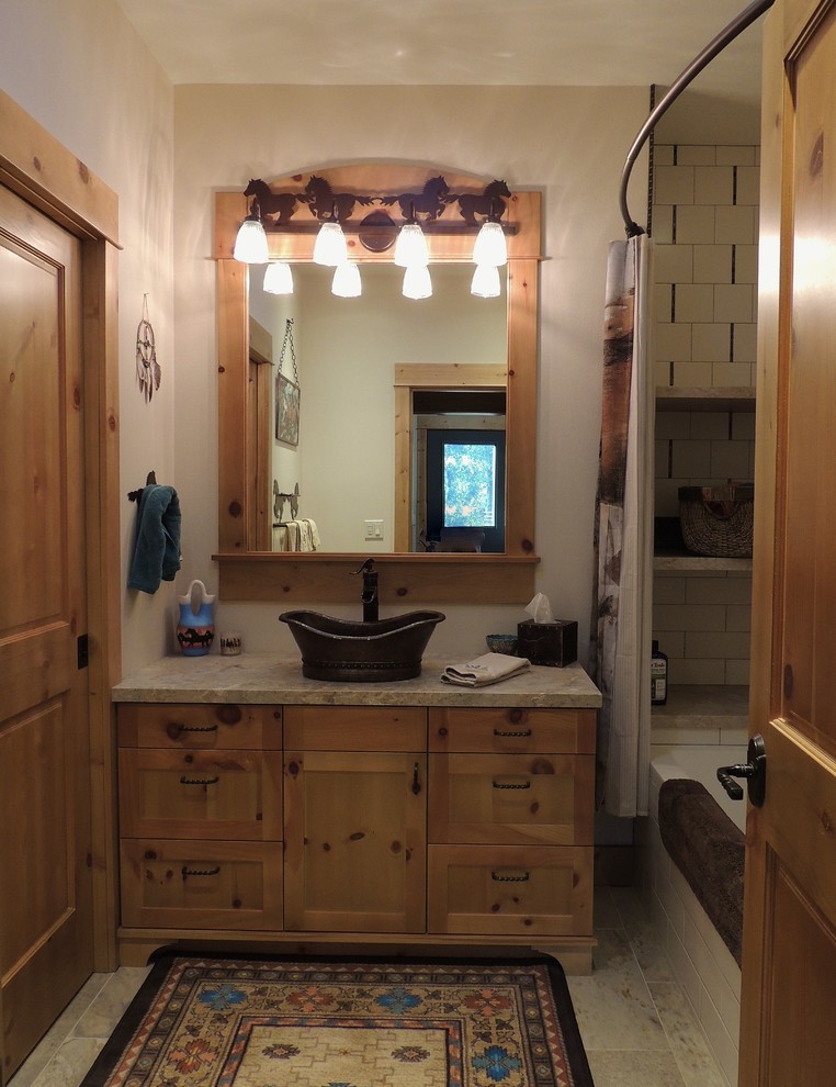 Exemple d'une salle de bain sud-ouest américain en bois brun avec un placard à porte shaker, une baignoire en alcôve, un combiné douche/baignoire, un carrelage blanc, mosaïque, un mur blanc, un sol en carrelage de porcelaine, une vasque, un plan de toilette en calcaire, un sol multicolore et une cabine de douche avec un rideau.