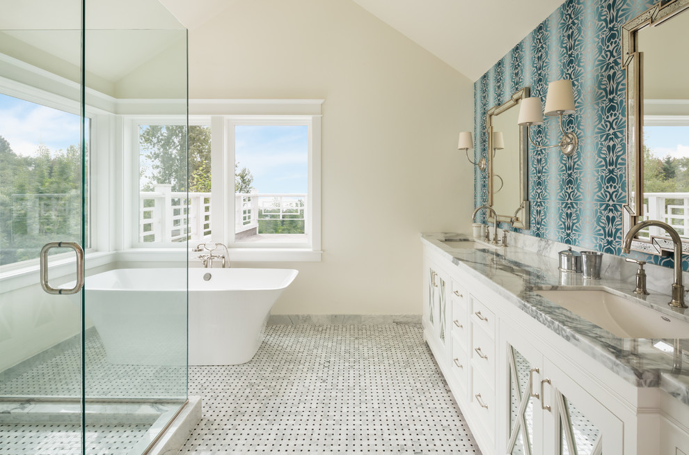 Traditional bathroom in Portland with white cabinets, a freestanding bath and feature lighting.