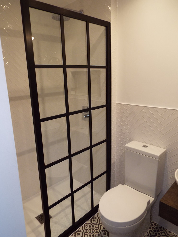 This is an example of a medium sized romantic ensuite bathroom in London with open cabinets, dark wood cabinets, a walk-in shower, a two-piece toilet, white tiles, ceramic tiles, white walls, ceramic flooring, a vessel sink, wooden worktops, black floors, an open shower and brown worktops.
