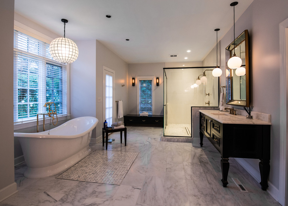 Inspiration for a large traditional ensuite bathroom in New York with freestanding cabinets, black cabinets, a freestanding bath, a double shower, black and white tiles, mosaic tiles, grey walls, marble flooring, a submerged sink and marble worktops.