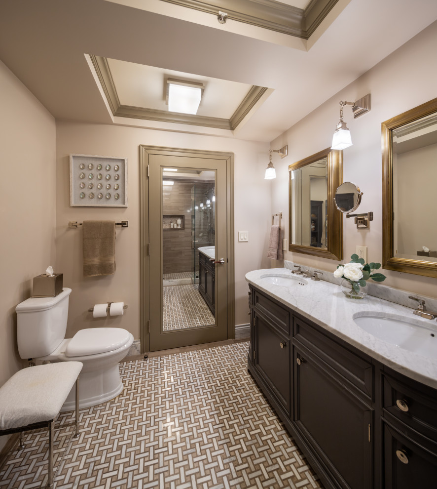 Elegant mosaic tile floor, beige floor, double-sink and tray ceiling bathroom photo in New York with recessed-panel cabinets, black cabinets, beige walls, an undermount sink, white countertops and a built-in vanity