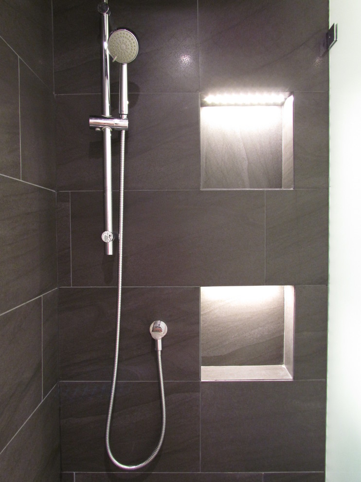 Inspiration for a small modern shower room bathroom in Vancouver with flat-panel cabinets, porcelain tiles, dark wood cabinets, a two-piece toilet, white tiles, white walls, a wall-mounted sink and solid surface worktops.
