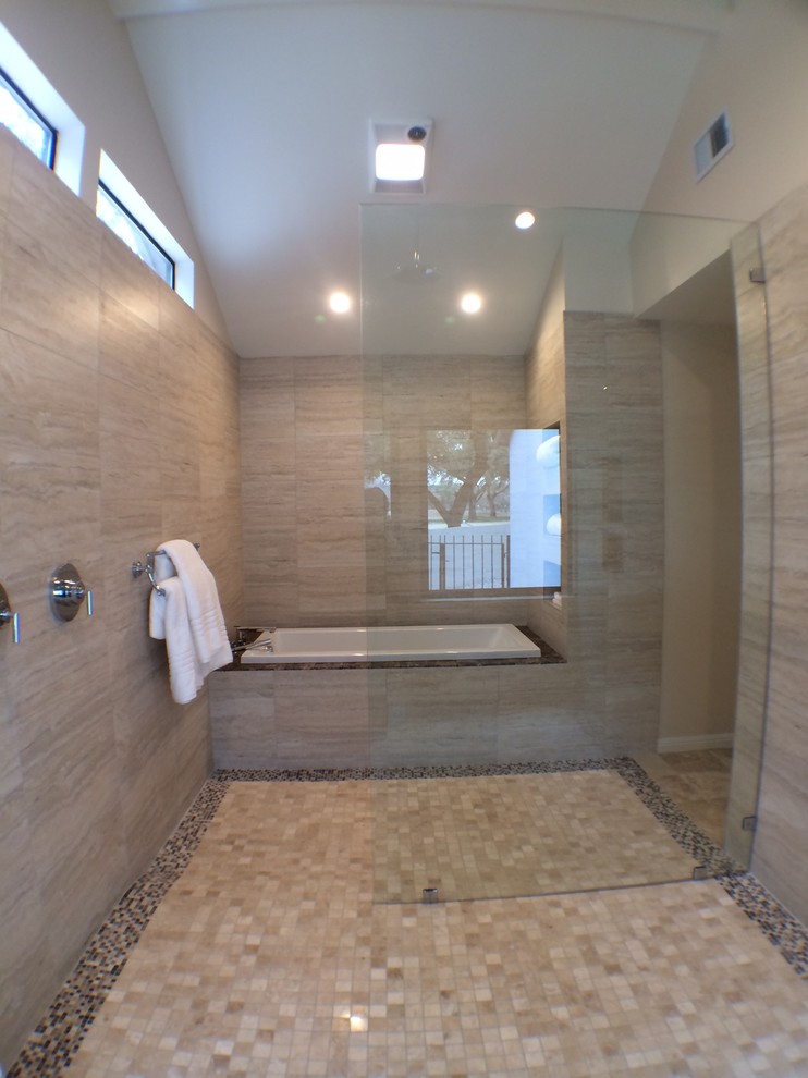 Large modern ensuite bathroom in Austin with shaker cabinets, white cabinets, a built-in bath, a built-in shower, a one-piece toilet, beige tiles, porcelain tiles, beige walls, travertine flooring, a submerged sink and wooden worktops.