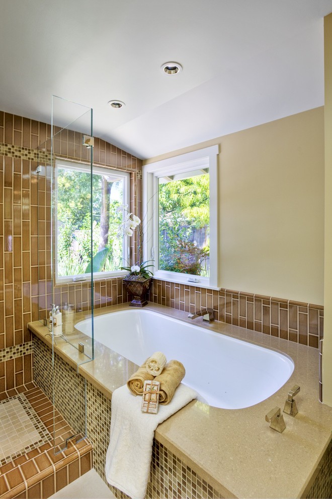 Large classic ensuite bathroom in San Francisco with a submerged bath, a corner shower, beige tiles, beige walls, a vessel sink, white cabinets, a two-piece toilet and ceramic flooring.