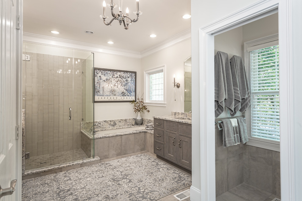 Large traditional ensuite bathroom in Other with beaded cabinets, grey cabinets, a submerged bath, a corner shower, a one-piece toilet, grey tiles, ceramic tiles, grey walls, porcelain flooring, a submerged sink and granite worktops.