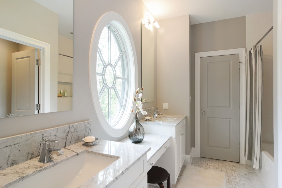 Bathroom - mid-sized traditional kids' gray tile and stone tile marble floor bathroom idea in Chicago with an undermount sink, raised-panel cabinets, white cabinets, marble countertops, a two-piece toilet and gray walls