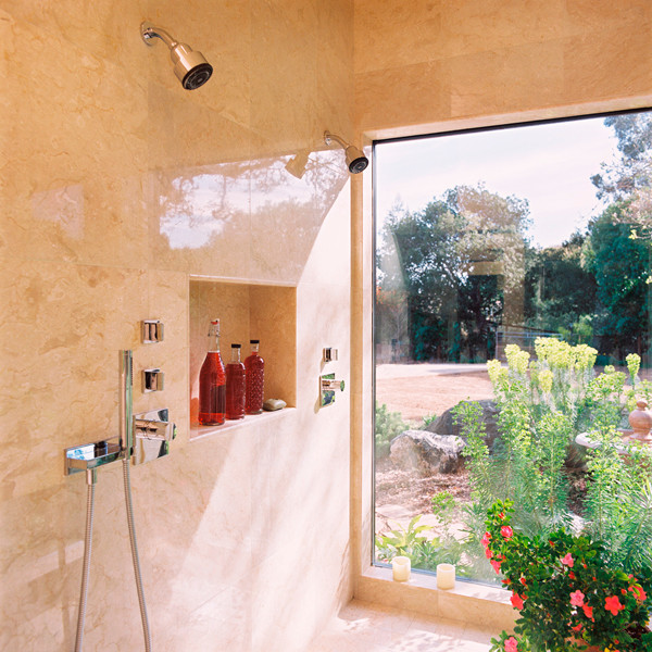 Inspiration for a medium sized traditional ensuite bathroom in San Francisco with flat-panel cabinets, orange cabinets, a submerged bath, a built-in shower, a wall mounted toilet, beige tiles, marble tiles, beige walls, marble flooring, a submerged sink, limestone worktops, beige floors, an open shower, grey worktops, double sinks, a floating vanity unit, all types of ceiling and all types of wall treatment.