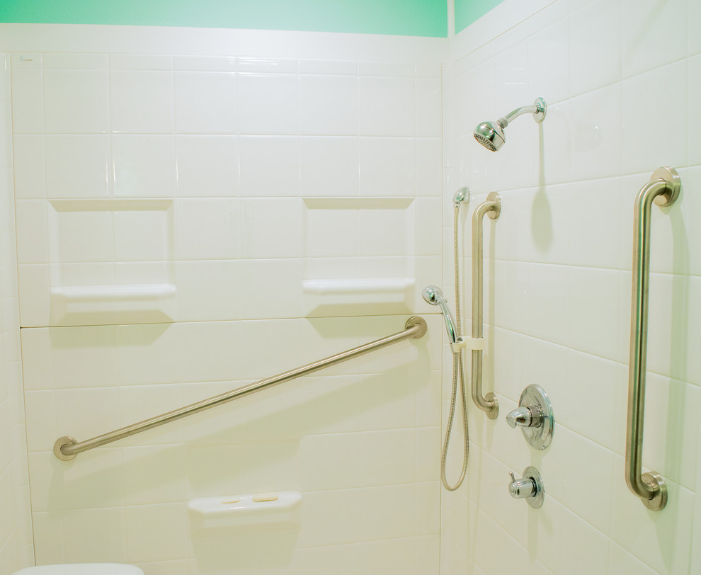 ニューオリンズにある中くらいなトラディショナルスタイルのおしゃれなバスルーム (浴槽なし) (中間色木目調キャビネット、バリアフリー、分離型トイレ、青い壁、アンダーカウンター洗面器、茶色い床、シャワーカーテン) の写真