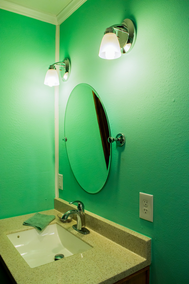 Photo of a medium sized traditional shower room bathroom in New Orleans with medium wood cabinets, a built-in shower, a two-piece toilet, blue walls, a submerged sink, brown floors and a shower curtain.