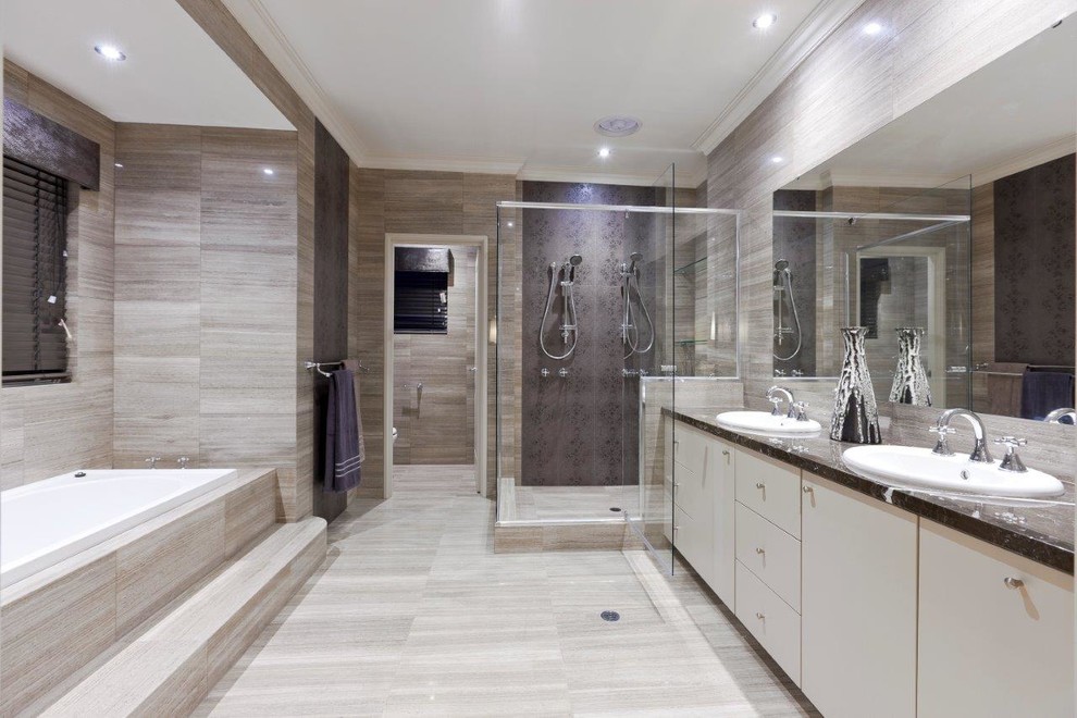 Photo of a large modern ensuite bathroom in Perth with flat-panel cabinets, brown cabinets, a double shower, a one-piece toilet, brown tiles, stone tiles, brown walls, travertine flooring, a built-in sink, granite worktops, brown floors, a hinged door, brown worktops, an enclosed toilet, double sinks and a built in vanity unit.