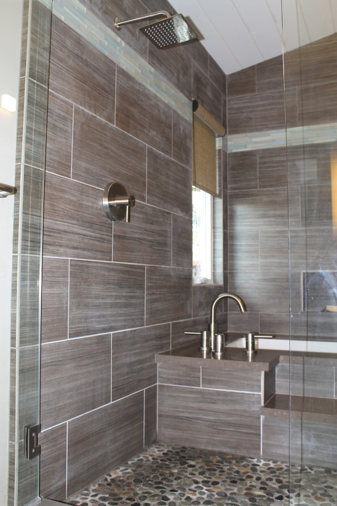 Photo of a medium sized contemporary shower room bathroom in San Francisco with glass-front cabinets, dark wood cabinets, a submerged bath, a shower/bath combination, a two-piece toilet, grey tiles, stone tiles, white walls, porcelain flooring, a submerged sink, engineered stone worktops, beige floors, a hinged door, green worktops, a shower bench, double sinks, a floating vanity unit and a vaulted ceiling.