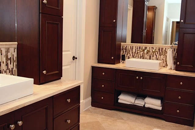 Example of a mid-sized trendy master beige tile, brown tile, white tile and mosaic tile travertine floor bathroom design in Chicago with recessed-panel cabinets, dark wood cabinets, beige walls, a pedestal sink and limestone countertops