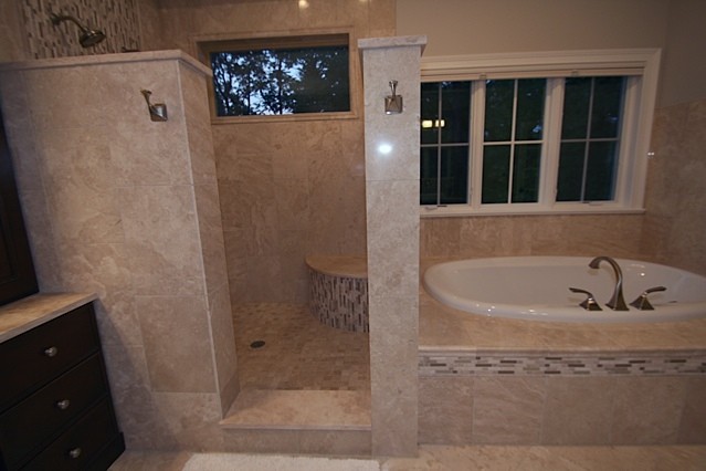 Photo of a medium sized contemporary ensuite bathroom in Chicago with recessed-panel cabinets, dark wood cabinets, a built-in bath, a corner shower, beige tiles, brown tiles, white tiles, mosaic tiles, beige walls, travertine flooring, a pedestal sink and limestone worktops.