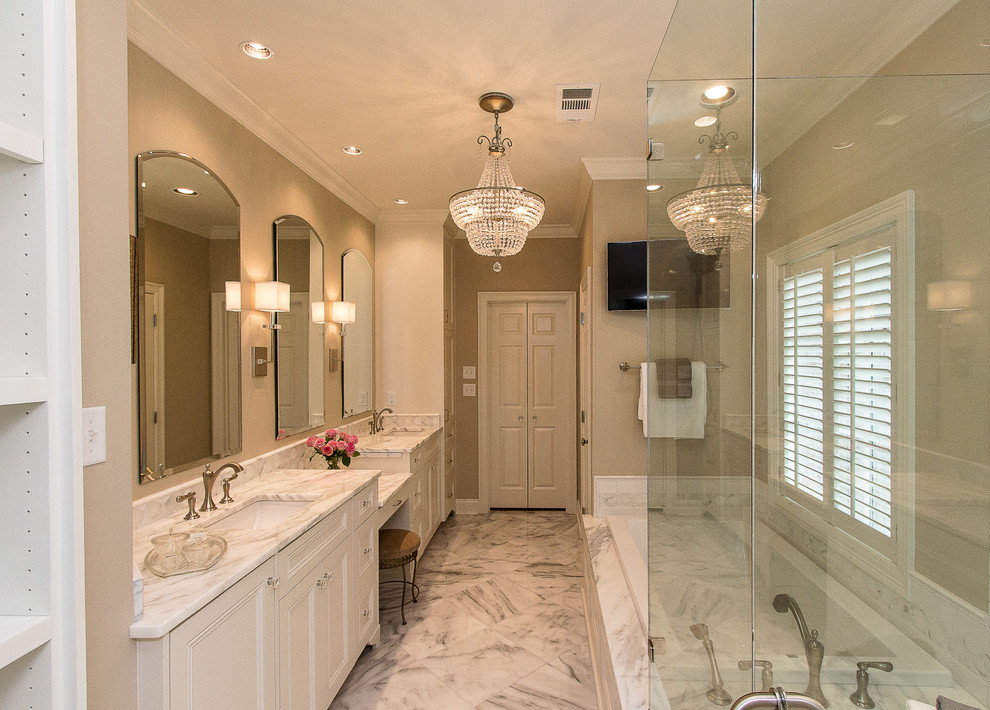 Bathroom - mid-sized transitional master white tile and subway tile marble floor bathroom idea in New Orleans with an undermount sink, recessed-panel cabinets, white cabinets, marble countertops and a one-piece toilet