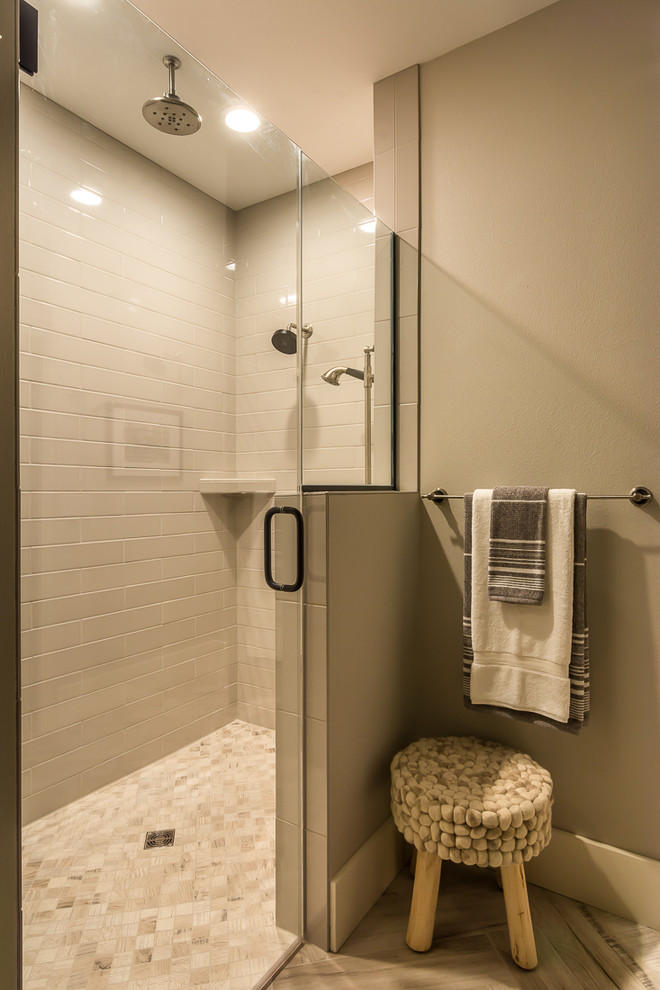 Example of a mid-sized transitional master beige tile and stone tile slate floor alcove shower design in Cedar Rapids with shaker cabinets, brown cabinets, a one-piece toilet, gray walls, an undermount sink and granite countertops