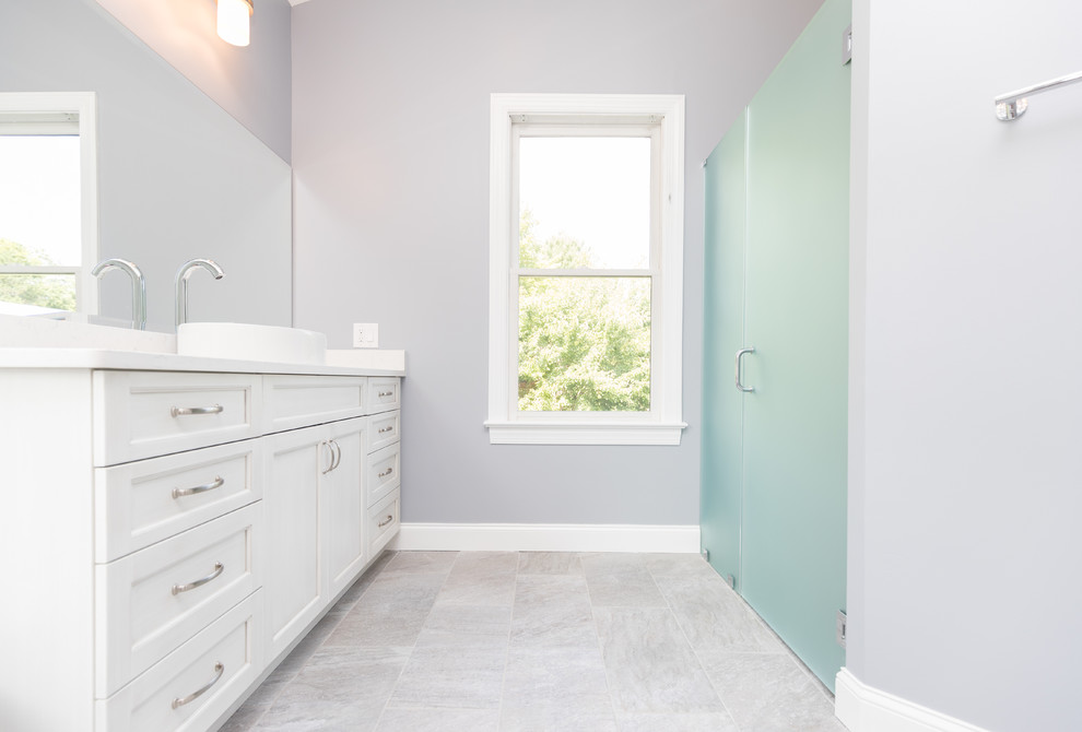 This is an example of a large traditional ensuite bathroom in DC Metro with shaker cabinets, white cabinets, a freestanding bath, an alcove shower, a two-piece toilet, white tiles, porcelain tiles, grey walls, slate flooring, a vessel sink and engineered stone worktops.
