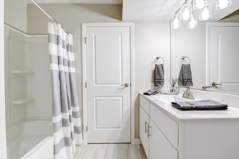 Medium sized traditional family bathroom in Chicago with white cabinets, an alcove bath, an alcove shower, grey walls, ceramic flooring, grey floors, a hinged door and double sinks.