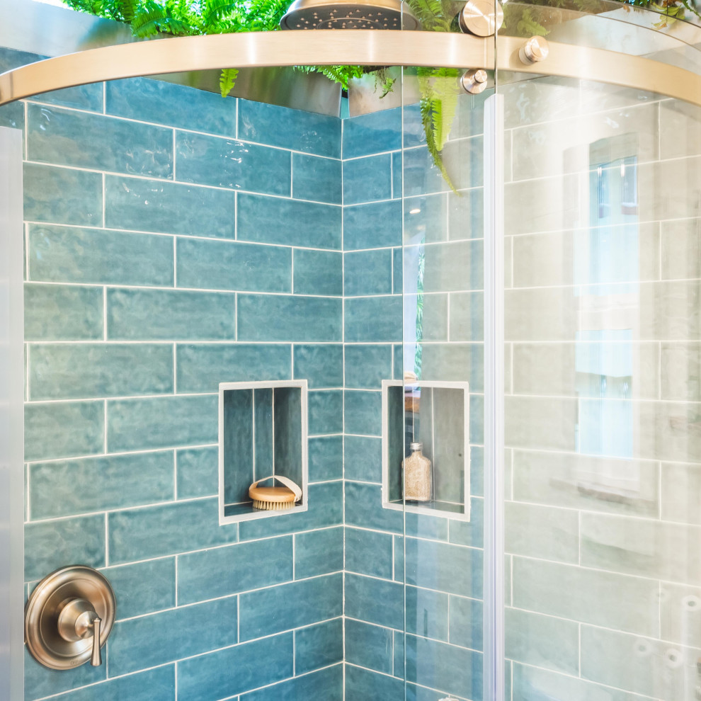 Design ideas for a small beach style shower room bathroom in Hawaii with open cabinets, light wood cabinets, a corner shower, a two-piece toilet, blue tiles, ceramic tiles, white walls, laminate floors, a vessel sink, wooden worktops, brown floors, a sliding door, brown worktops, a wall niche, a single sink, a floating vanity unit and a vaulted ceiling.