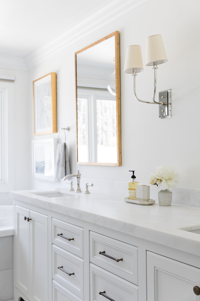 Inspiration for a mid-sized coastal master white tile white floor bathroom remodel in Salt Lake City with white cabinets, white walls, marble countertops, a hinged shower door and white countertops