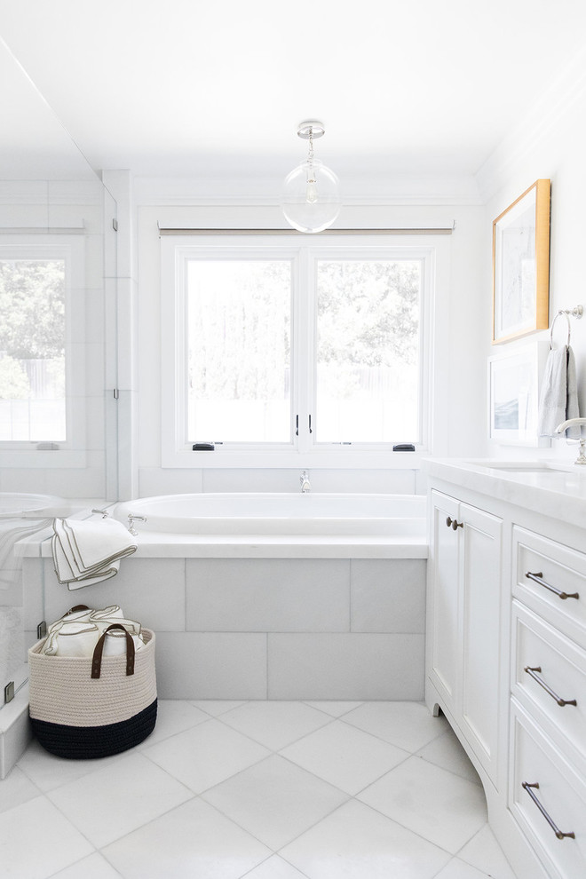 Ejemplo de cuarto de baño marinero de tamaño medio con puertas de armario blancas, baldosas y/o azulejos blancos, paredes blancas, suelo blanco, ducha con puerta con bisagras y encimeras blancas