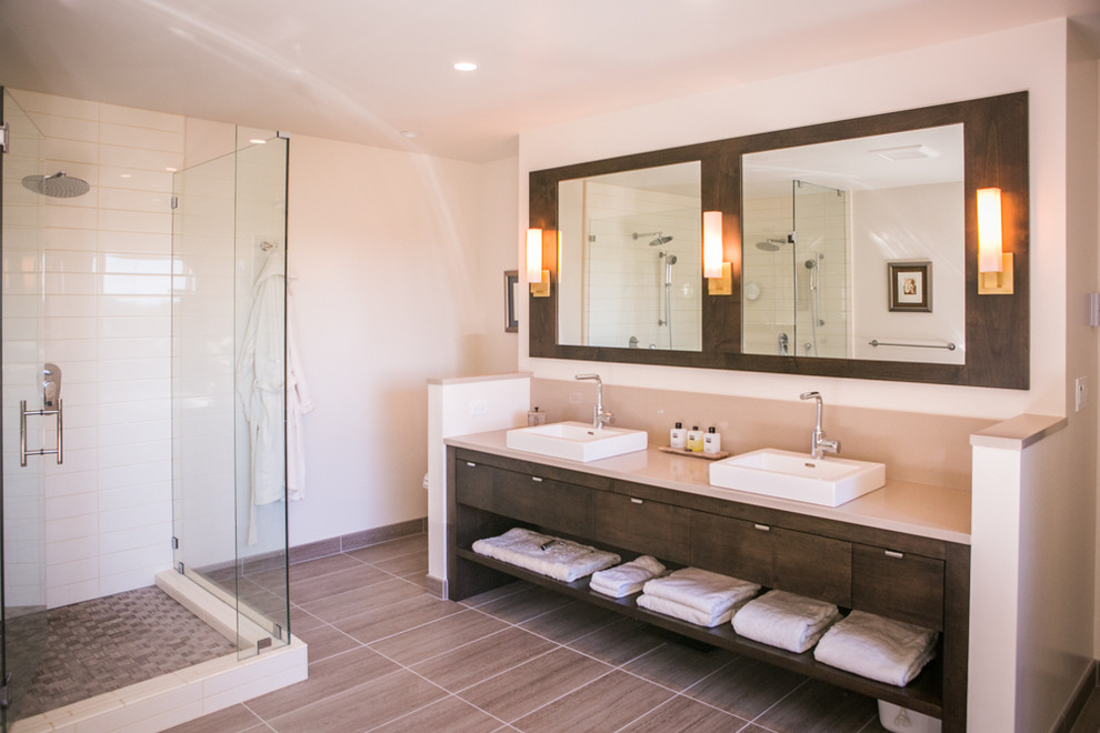 Bathroom - large contemporary master white tile and ceramic tile porcelain tile and brown floor bathroom idea in San Francisco with flat-panel cabinets, dark wood cabinets, a one-piece toilet, a vessel sink, quartz countertops, a hinged shower door and beige walls