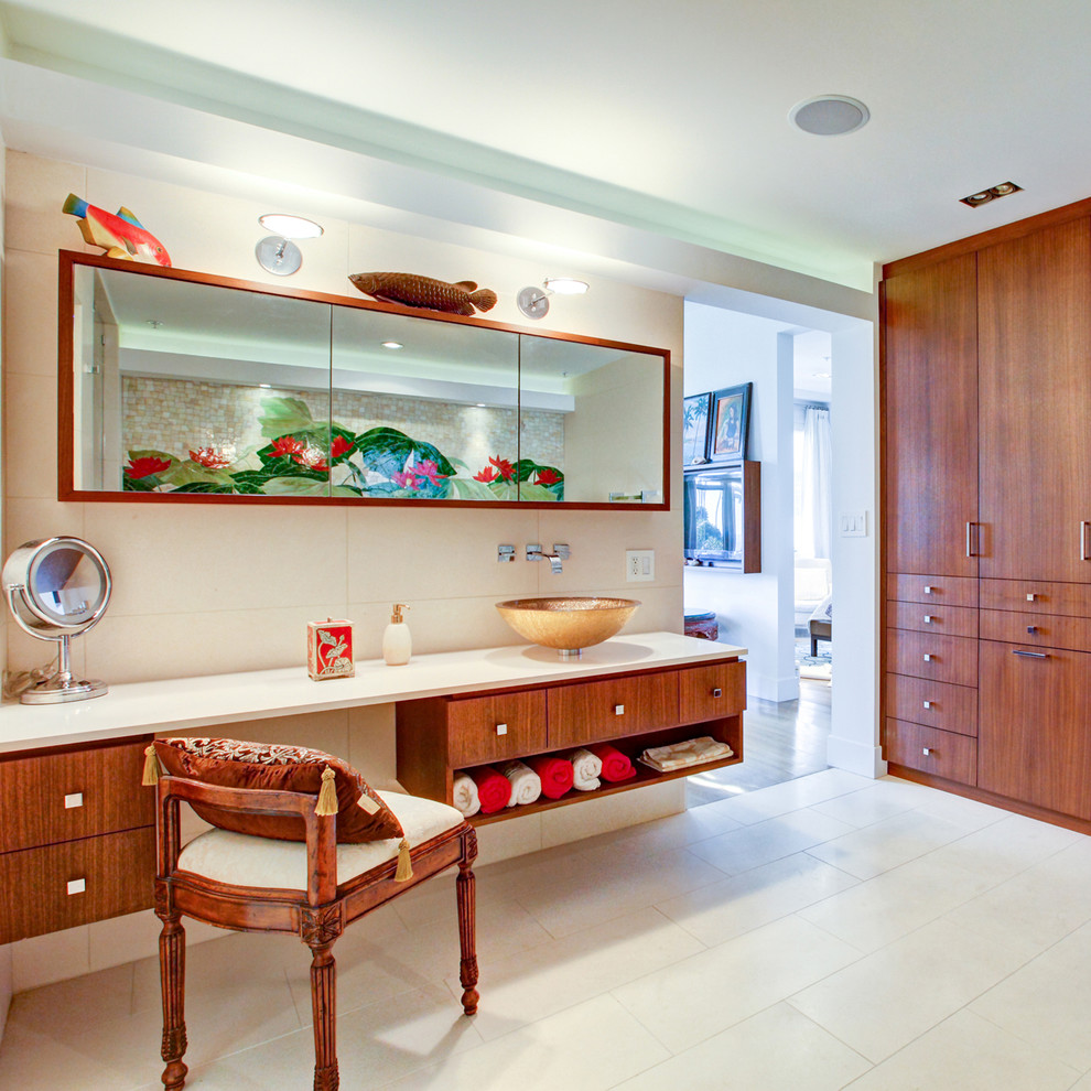 Contemporary bathroom in Los Angeles with a vessel sink, flat-panel cabinets, medium wood cabinets and beige tiles.