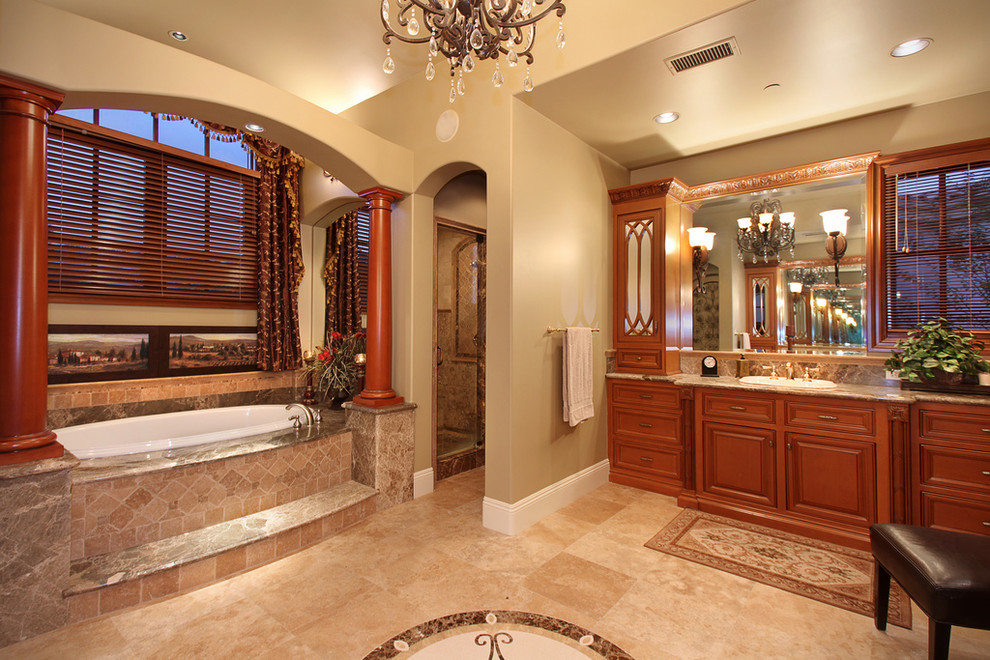 На фото: ванная комната в классическом стиле с накладной раковиной, фасадами с выступающей филенкой, фасадами цвета дерева среднего тона, накладной ванной, бежевой плиткой и окном с