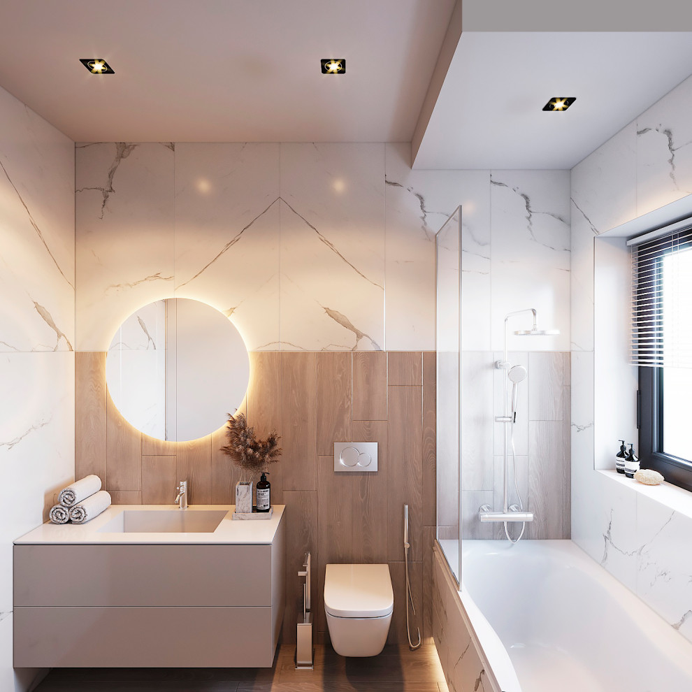 Modern inredning av ett mellanstort grå grått badrum med dusch, med släta luckor, grå skåp, ett badkar i en alkov, en dusch/badkar-kombination, grå kakel, vit kakel, ett integrerad handfat, brunt golv och med dusch som är öppen