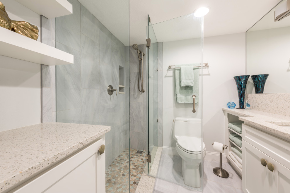 Design ideas for a medium sized nautical shower room bathroom in Orlando with recessed-panel cabinets, white cabinets, a corner shower, grey tiles, porcelain tiles, grey walls, porcelain flooring, a submerged sink, recycled glass worktops, grey floors, a hinged door and white worktops.