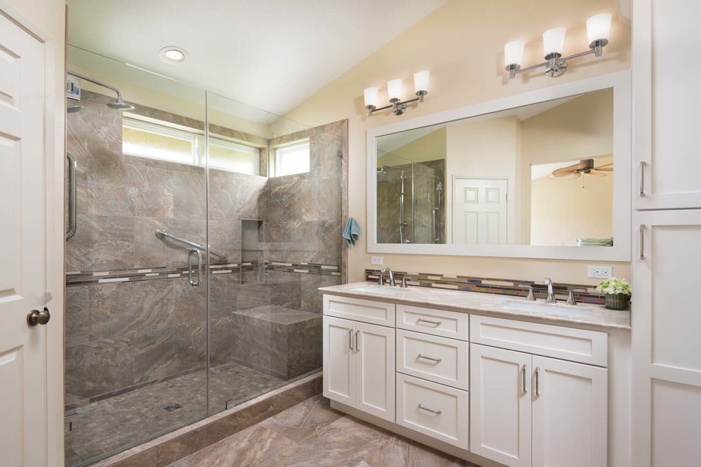 Large contemporary ensuite bathroom in San Diego with a submerged sink, shaker cabinets, white cabinets, marble worktops, an alcove shower, a one-piece toilet, multi-coloured tiles, porcelain tiles, beige walls and porcelain flooring.