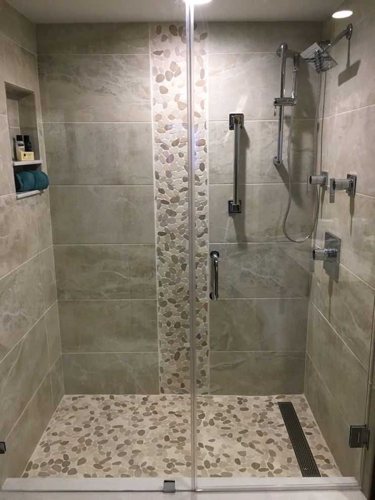 Large island style 3/4 gray tile and porcelain tile pebble tile floor and beige floor bathroom photo in Other with gray walls, a hinged shower door, raised-panel cabinets, an undermount sink, granite countertops, white cabinets, a two-piece toilet and gray countertops