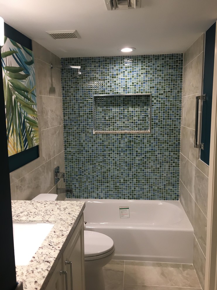 Mid-sized island style 3/4 blue tile and mosaic tile cement tile floor and beige floor bathroom photo in Boston with raised-panel cabinets, white cabinets, a two-piece toilet, an undermount sink, granite countertops and white countertops