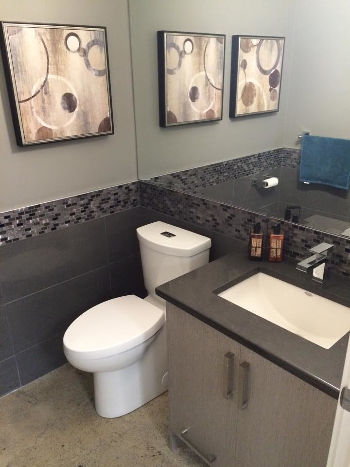 Kleines Modernes Duschbad mit Unterbauwaschbecken, flächenbündigen Schrankfronten, grauen Schränken, Quarzwerkstein-Waschtisch, schwarzen Fliesen, grauer Wandfarbe und Betonboden in Calgary