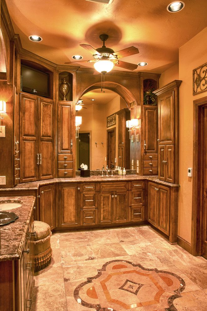 Alcove shower - large rustic master beige tile and stone tile marble floor and brown floor alcove shower idea in Dallas with raised-panel cabinets, medium tone wood cabinets, a one-piece toilet, beige walls, an undermount sink and marble countertops