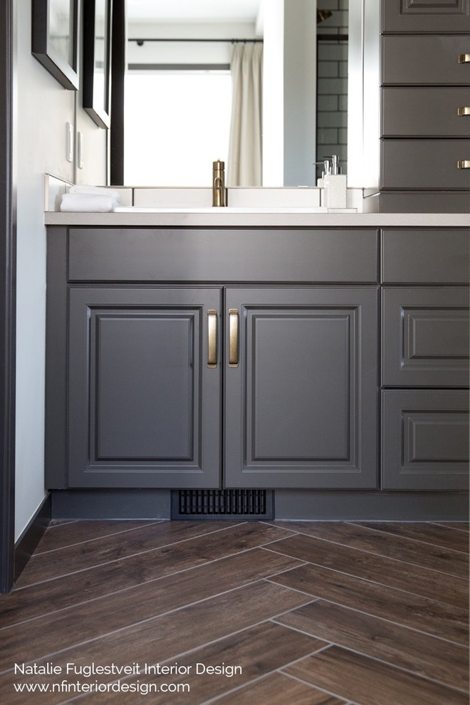 Inspiration for a small classic ensuite bathroom in Calgary with raised-panel cabinets, grey cabinets, an alcove shower, a two-piece toilet, white tiles, ceramic tiles, white walls, porcelain flooring, a built-in sink and laminate worktops.
