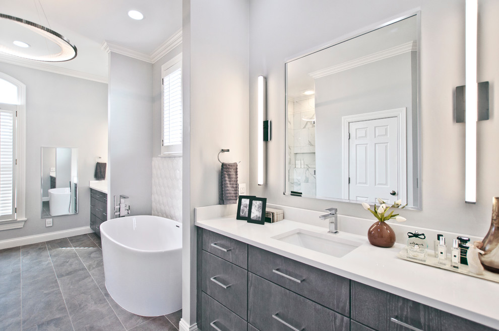 Inspiration for a large contemporary master white tile and ceramic tile slate floor and gray floor bathroom remodel in Nashville with flat-panel cabinets, gray cabinets, a two-piece toilet, gray walls, an undermount sink, quartz countertops, a hinged shower door and white countertops
