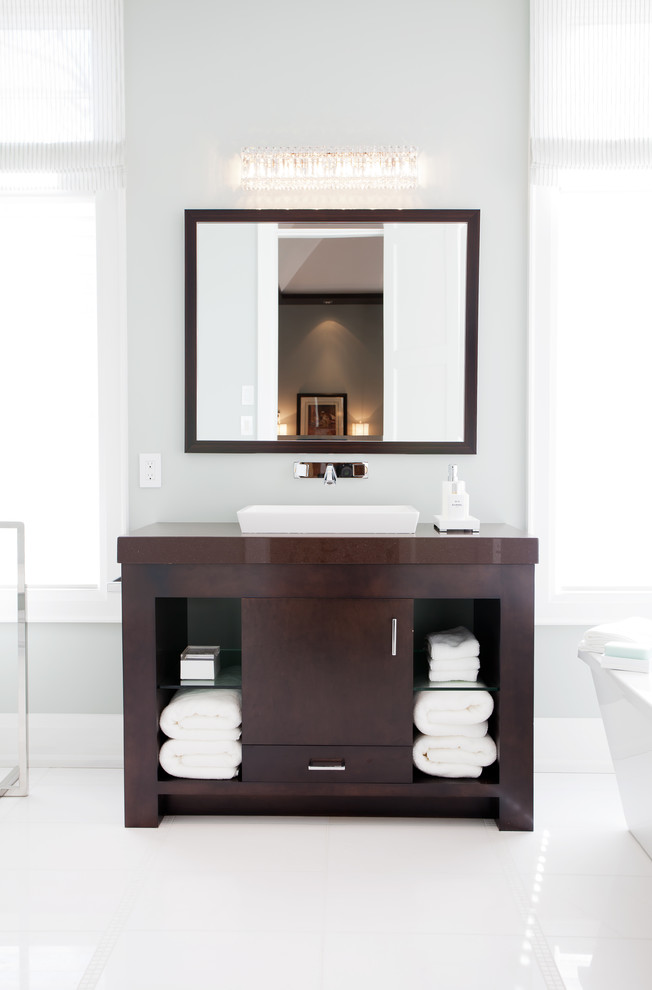 Inspiration for a large contemporary ensuite bathroom in Toronto with a built-in sink, freestanding cabinets, dark wood cabinets, engineered stone worktops, white tiles, ceramic tiles, grey walls and marble flooring.