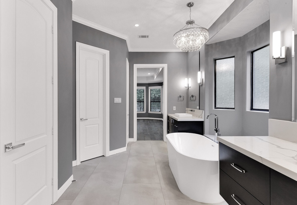 Inspiration for a medium sized modern ensuite bathroom in Houston with freestanding cabinets, dark wood cabinets, a freestanding bath, a built-in shower, grey tiles, ceramic tiles, grey walls, cement flooring, a submerged sink, engineered stone worktops, grey floors, a hinged door, white worktops, double sinks and a floating vanity unit.