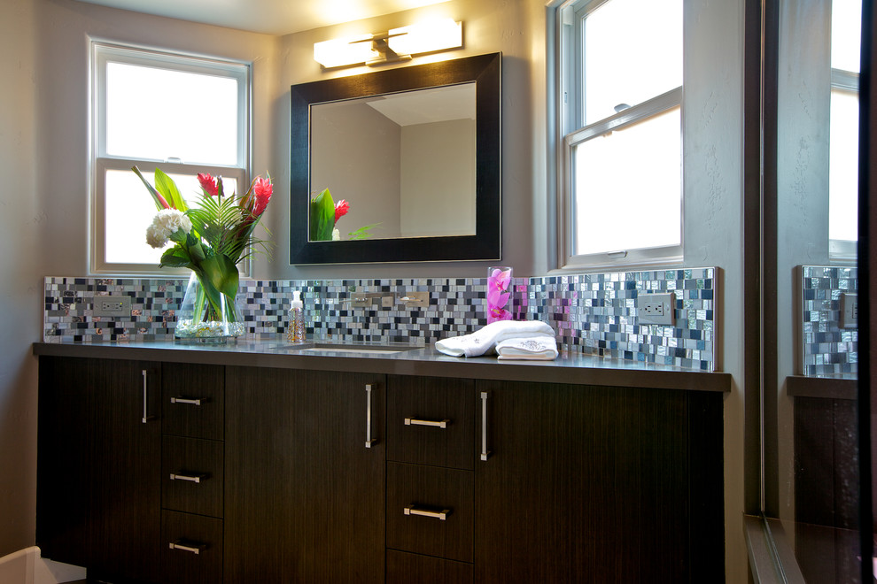 Example of a mid-sized trendy master multicolored tile and mosaic tile porcelain tile and gray floor walk-in shower design in San Diego with flat-panel cabinets, dark wood cabinets, solid surface countertops, gray walls, an undermount sink and a hinged shower door