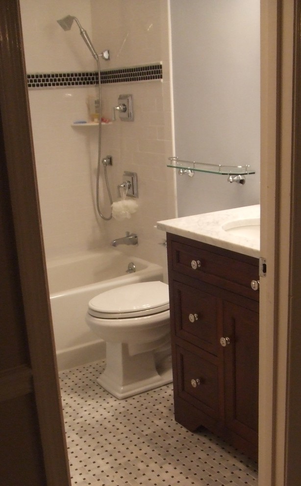 Inspiration for a mid-sized timeless 3/4 white tile and stone tile marble floor bathroom remodel in DC Metro with an undermount sink, beaded inset cabinets, dark wood cabinets, marble countertops, a two-piece toilet and blue walls