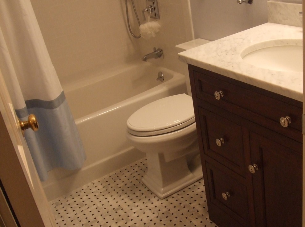 Bathroom - mid-sized transitional 3/4 white tile and stone tile marble floor bathroom idea in DC Metro with an undermount sink, beaded inset cabinets, dark wood cabinets, marble countertops, a two-piece toilet and blue walls