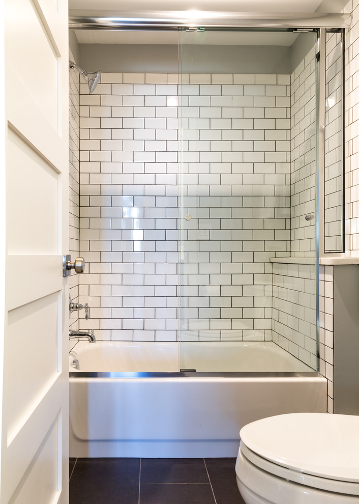 Photo of a medium sized industrial family bathroom in Denver with shaker cabinets, dark wood cabinets, an alcove bath, a shower/bath combination, white tiles, ceramic tiles, grey walls, ceramic flooring, a submerged sink, quartz worktops, a one-piece toilet and an open shower.