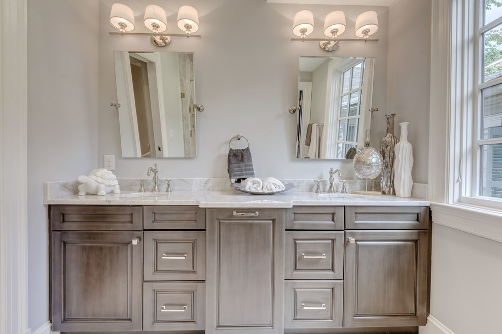 Ejemplo de cuarto de baño principal clásico renovado grande con armarios con paneles con relieve, puertas de armario grises, ducha esquinera, paredes blancas, lavabo bajoencimera y encimera de cuarcita
