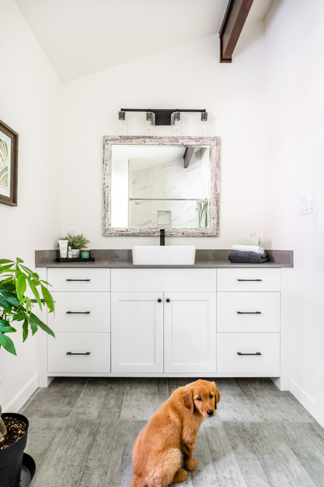 Example of a transitional single-sink and vaulted ceiling bathroom design in Vancouver with a built-in vanity