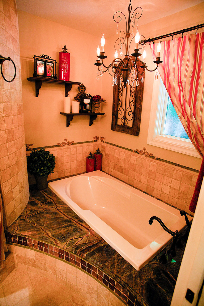 Photo of a medium sized mediterranean bathroom in Sacramento with granite worktops, a built-in bath, beige tiles, stone tiles, beige walls, travertine flooring, raised-panel cabinets, green cabinets, an alcove shower, a two-piece toilet and a submerged sink.