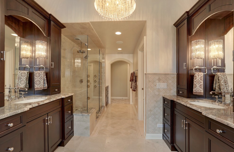 Photo of a large classic ensuite bathroom in Chicago with a submerged sink, recessed-panel cabinets, dark wood cabinets, granite worktops, a double shower, beige tiles, ceramic tiles, white walls and ceramic flooring.